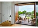 Private balcony with wooden deck, wicker chairs, and city view at 202 Dundas Ln, Raleigh, NC 27603