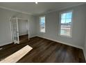 Bright, empty living room with dark hardwood floors and plenty of natural light at 25 Accord Dr, Youngsville, NC 27596