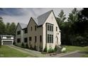 Side view of a two-story house with white brick and gray siding, a gabled roof and attached garage at 2650 Marchmont Street St, Raleigh, NC 27608