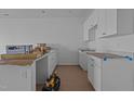 New construction kitchen with white cabinets and countertops at 2995 Faucette Ln, Burlington, NC 27217