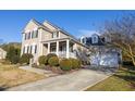 Attractive home showcasing landscaped front yard, long driveway, and appealing exterior color scheme at 30155 Pharr, Chapel Hill, NC 27517