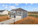 Modern two-story home with an attached garage, neatly paved driveway, and manicured front lawn at 3615 Nc-62, Burlington, NC 27217