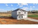 Modern two-story home with an attached garage, neatly paved driveway, and ready to be landscaped front lawn at 3615 Nc-62, Burlington, NC 27217