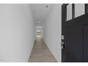 Long hallway with modern gray vinyl flooring and neutral walls leading to an open living space at 3615 Nc-62, Burlington, NC 27217