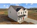 Rear exterior of a charming two-story home surrounded by lush greenery and natural light at 3649 Nc-62, Burlington, NC 27217