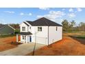 Charming two-story white home featuring an attached garage and an unfinished yard at 3655 Nc-62, Burlington, NC 27217