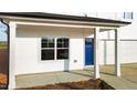 Inviting covered front porch with white columns and a bright blue entry door at 3655 Nc-62, Burlington, NC 27217