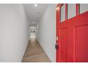 Bright foyer features a striking red front door, light-colored walls, and wood-look floors at 3689 Nc 62, Burlington, NC 27217