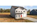 Charming two-story home features a gray exterior, red front door, and attached two-car garage at 3689 Nc 62, Burlington, NC 27217