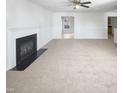 Spacious living room featuring a fireplace, carpet, and large window at 3810 Chehaw Dr, Raleigh, NC 27610