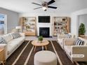 Cozy living room features a fireplace, ceiling fan, and built in bookshelves at 3810 Chehaw Dr, Raleigh, NC 27610