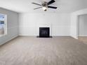 Bright living room features a fireplace, carpet, and large window at 3810 Chehaw Dr, Raleigh, NC 27610