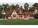 Stunning two-story home with a brick and wood exterior, and landscaped lawn at 3813 Peaceful Creek Trl, Zebulon, NC 27597