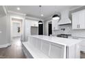 White kitchen with breakfast bar, stainless steel appliances, and built-in bench seating at 3813 Peaceful Creek Trl, Zebulon, NC 27597