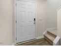 Front entry with white door, keypad lock, and carpeted stairs at 422 Honeycutt Oaks Dr, Angier, NC 27501