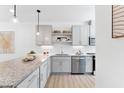 Modern kitchen with gray cabinets, granite counters, and stainless steel appliances at 4801 Gossamer Ln # 104, Raleigh, NC 27616