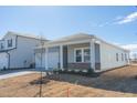 New home with gray siding, two-car garage, and a covered porch at 483 White Birch Ln, Angier, NC 27501