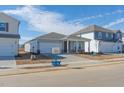 New house with gray siding, two-car garage, and a front yard at 483 White Birch Ln, Angier, NC 27501