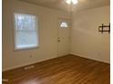 Bright room with hardwood floors, ceiling fan, and a window at 494 S Mason St, Coats, NC 27521