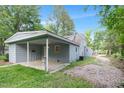 View of the back of the house featuring an attached carport and spacious yard at 621 Shepard School Rd, Zebulon, NC 27597