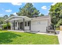 Charming white brick ranch home with a covered porch and well-maintained lawn at 816 Peyton St, Raleigh, NC 27610