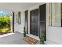 Dark wood front door with black shutters and potted plants at 816 Peyton St, Raleigh, NC 27610