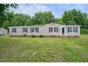 Mobile home with a large grassy yard at 95 Old Barn Ct, Rocky Mount, NC 27801