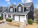Beautiful two story home featuring a two car garage and covered porch with an American flag at 101 Pointe Park Cir, Holly Springs, NC 27540