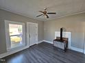 Living room with wood-burning stove and ceiling fan at 1101-1103 N Anthony St, Burlington, NC 27217