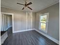 Bright living room with grey walls, grey flooring, and ceiling fan at 1101-1103 N Anthony St, Burlington, NC 27217