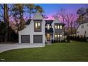Twilight view of this beautiful two-story home and yard with convenient two-car garage at 1304 Ivy Ln, Raleigh, NC 27609