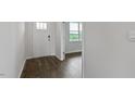 Bright foyer featuring hardwood floors, a white front door and natural light from a window at 145 Scenic Rock Dr, Youngsville, NC 27596