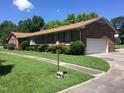 Brick ranch house with attached garage and landscaped yard at 1521 Nc-87, Elon, NC 27244