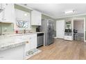 Bright kitchen with white cabinets, stainless steel appliances, granite countertops, and modern lighting at 1587 Crockers Nub Rd, Middlesex, NC 27557