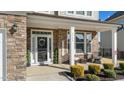 Inviting front porch with stone columns and welcoming decor at 2120 Blue Iris Way, Zebulon, NC 27597
