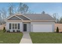 New single-story home with gray siding, a two-car garage, and landscaping at 214 Deodora Ln, Cameron, NC 28326