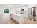 Bright kitchen featuring white cabinetry, stainless steel appliances, and a large center island at 29 Enterprise St # 107, Raleigh, NC 27607
