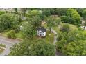 Aerial view showing a two-story white house with a large yard and surrounding trees at 309 Hawkins Ave, Sanford, NC 27330