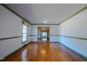 Bright living room with hardwood floors and large windows at 3129 Barwell Rd Rd, Raleigh, NC 27610