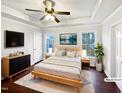 Virtually staged bedroom with hardwood floors and ceiling fan at 3321 Beech Bluff Ln, Raleigh, NC 27616