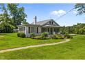 White house with red shutters, front porch, and walkway leading to entrance at 5306 Nc 54 Highway, Chapel Hill, NC 27516