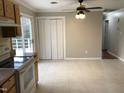 Open dining area featuring tile floor, a ceiling fan, and access to a balcony at 7317 Bentley Wood Ln, Raleigh, NC 27616