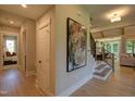 Bright hallway with stairs and large piece of art at 82 Byrd Ln, Pittsboro, NC 27312