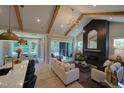 Spacious living area with high ceilings, exposed beams, and a floor to ceiling fireplace at 82 Byrd Ln, Pittsboro, NC 27312