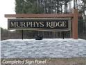Community entrance sign for Murphys Ridge, featuring a wood and stone design at Lot 6H Liatris Ln, Oxford, NC 27565