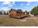 Log cabin with deck and steps leading to the yard at 1018 Lakeview Dr, Cedar Grove, NC 27231