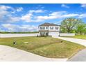 Exterior view of a two-story home featuring a front yard, driveway and white fence in the background at 108 Bonnie Girl Ct, Lillington, NC 27546
