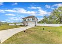 Exterior view of a two-story home with a driveway, front yard, basketball hoop and white fence at 108 Bonnie Girl Ct, Lillington, NC 27546