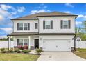 Two-story home featuring a front-facing two-car garage, white siding, and dark shutters at 108 Bonnie Girl Ct, Lillington, NC 27546