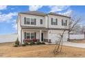 Charming two-story home featuring a covered porch and a two-car garage with landscaped front yard at 108 Bonnie Girl Ct, Lillington, NC 27546